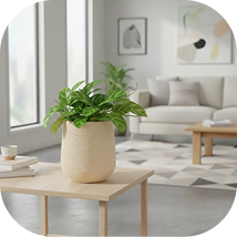 Maceta plástica beige mate símil piedra sobre una mesa de living moderno con planta verde.